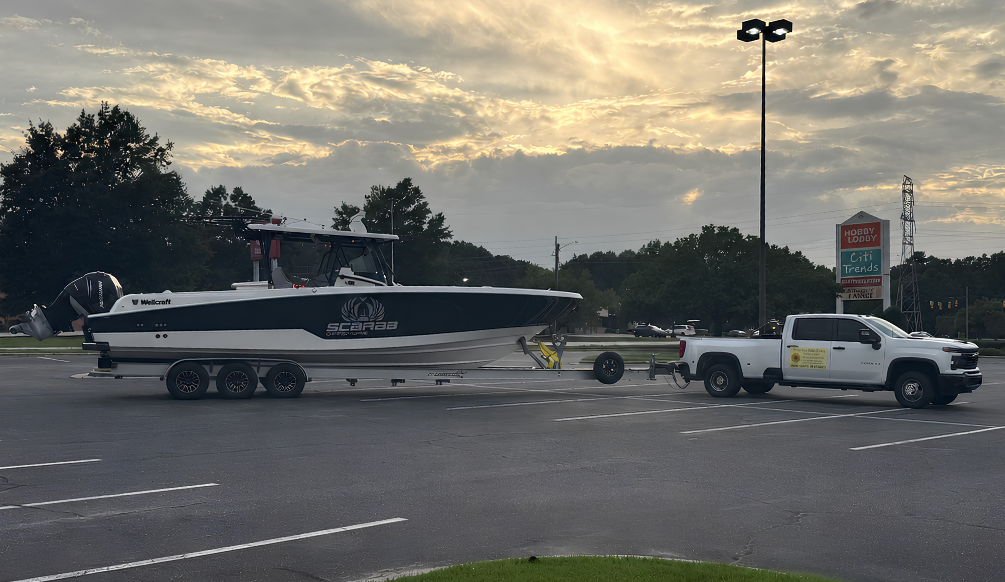 Hauling Miss Daisy truck towing a boat on a trailer